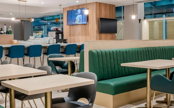 Plaza Premium Lounge seating area with bar at Vancouver International Airport (YVR).