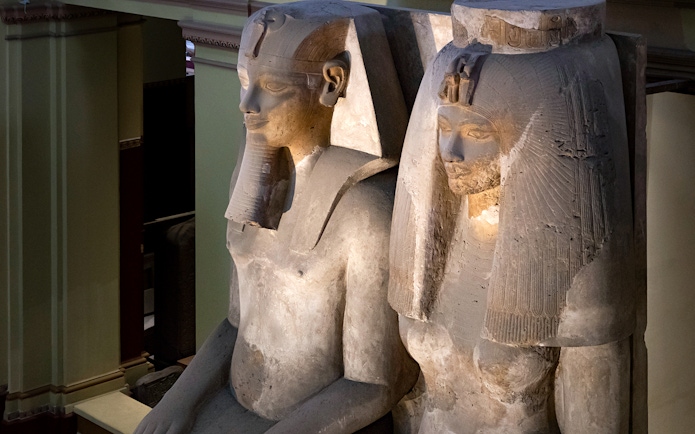 Seated statues of ancient Egyptian figures at the Grand Egyptian Museum.