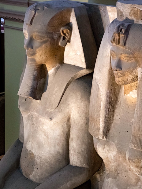 Seated statues of ancient Egyptian figures at the Grand Egyptian Museum.
