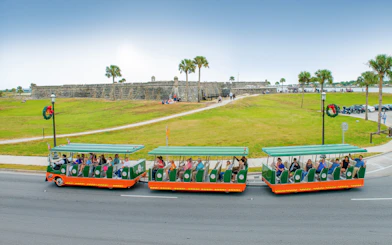 Old Town Trolley tour passing Castillo de San Marcos in St. Augustine.