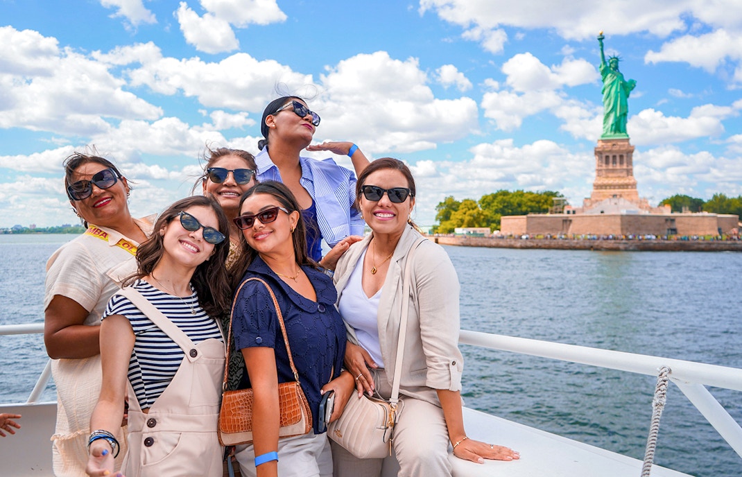 Statue of Liberty and New York City skyline from sightseeing cruise.