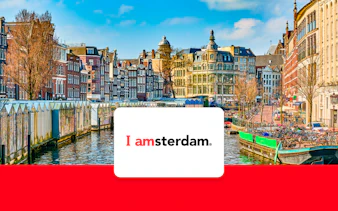 Amsterdam canal with historic buildings and bicycles in early spring.