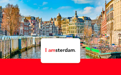 Amsterdam canal with historic buildings and bicycles in early spring.
