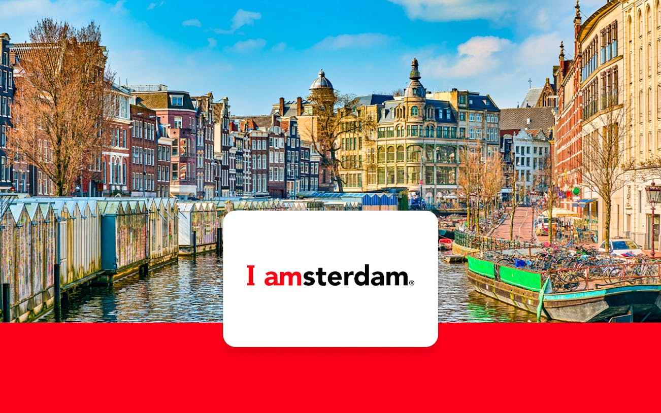 Amsterdam canal with historic buildings and bicycles in early spring.