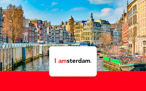 Amsterdam canal with historic buildings and bicycles in early spring.