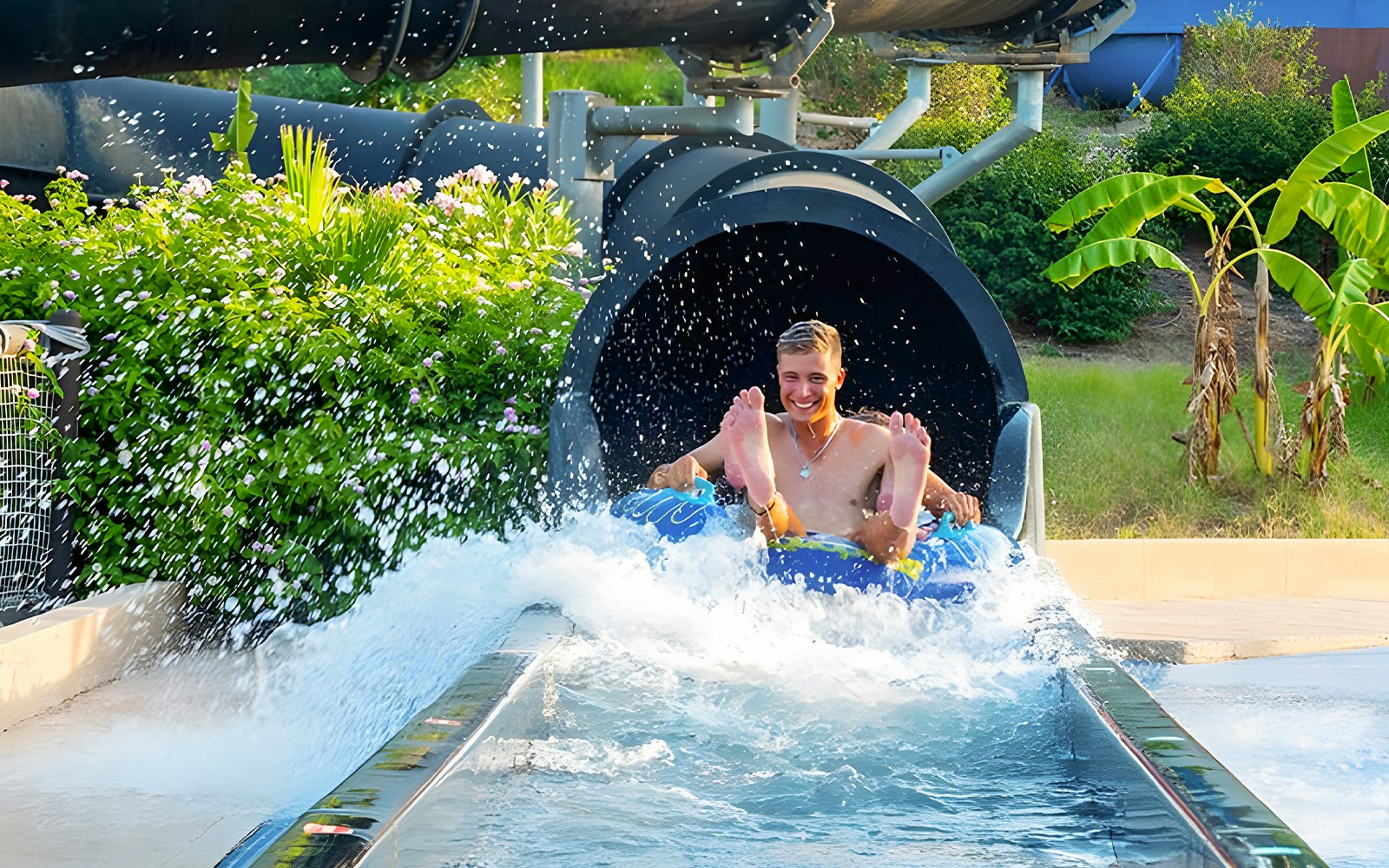 Riders exiting Black Hole slide at Aquopolis Torrevieja water park.