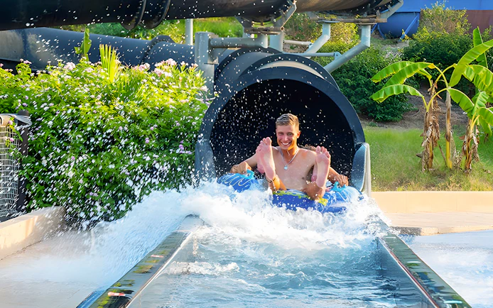 Riders exiting Black Hole slide at Aquopolis Torrevieja water park.