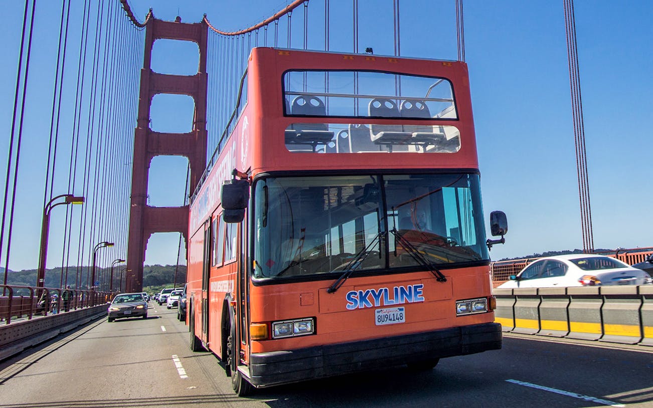 Double-decker tour bus crossing Golden Gate Bridge on Hop-On Hop-Off City Day Tour.
