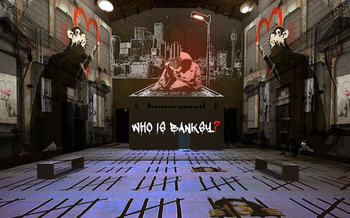 Inside Banksy unauthorized exhibition in Florence, featuring street art and "Who is Banksy?" display.