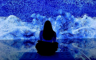 Visitor viewing digital art installation at ARTECHOUSE New York.