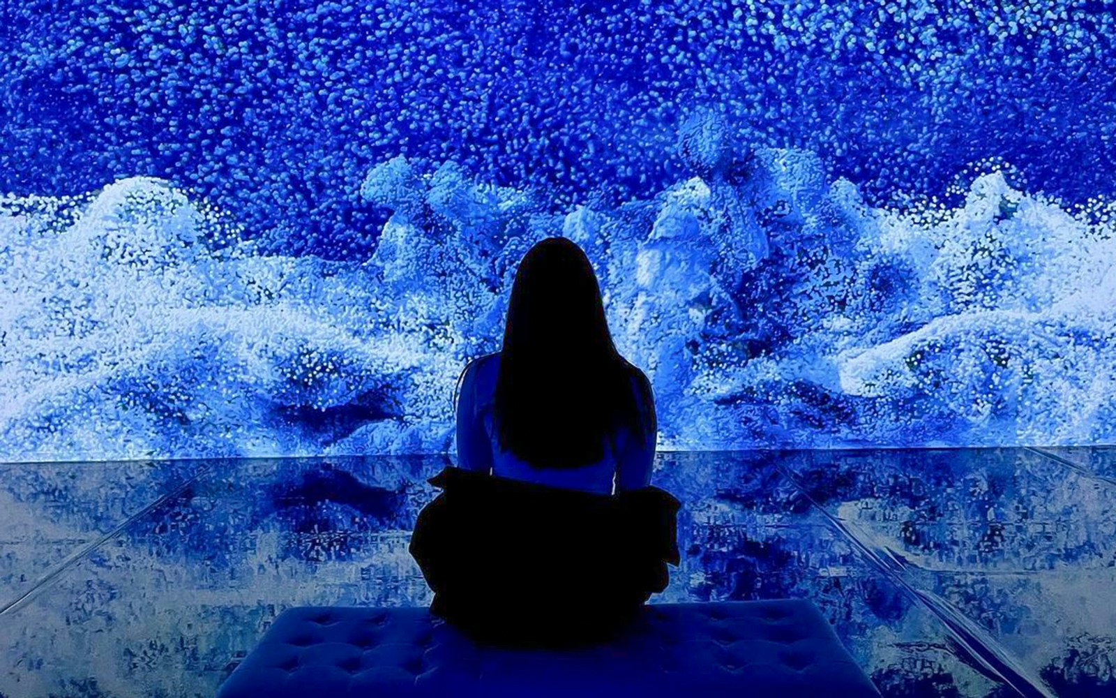 Visitor viewing digital art installation at ARTECHOUSE New York.