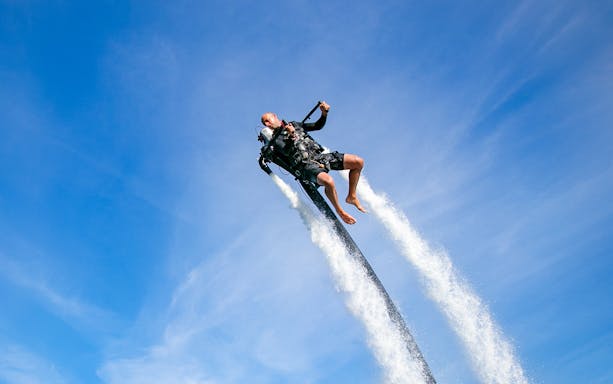 Person using a jetpack over water at The Palm Jumeirah, Dubai.