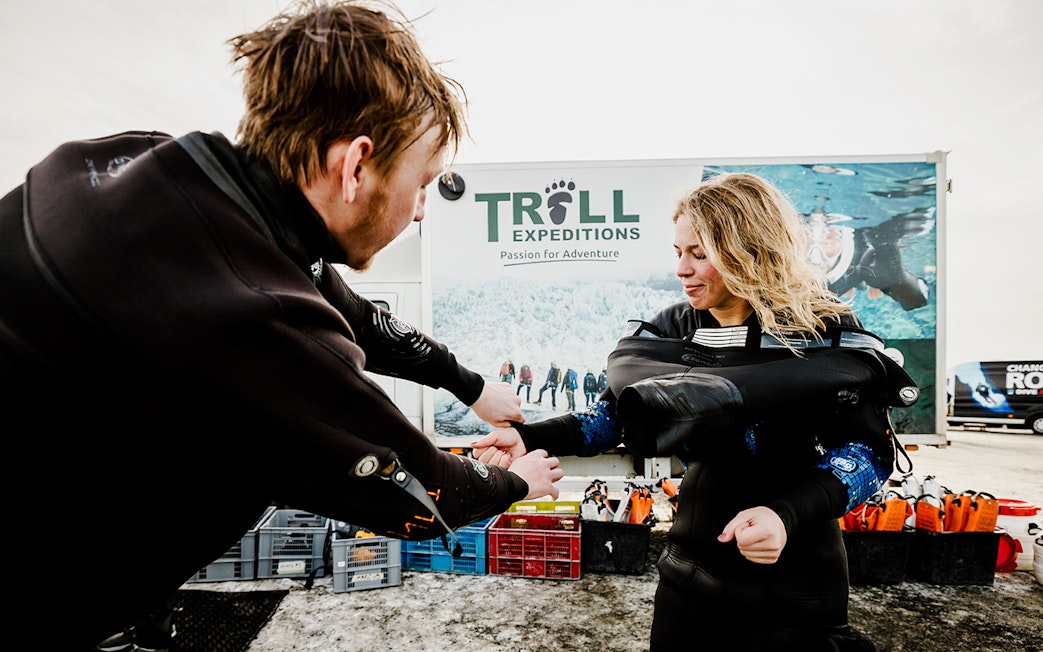 Guests preparing for snorkeling in Silfra Fissure, Iceland, wearing dry suits.