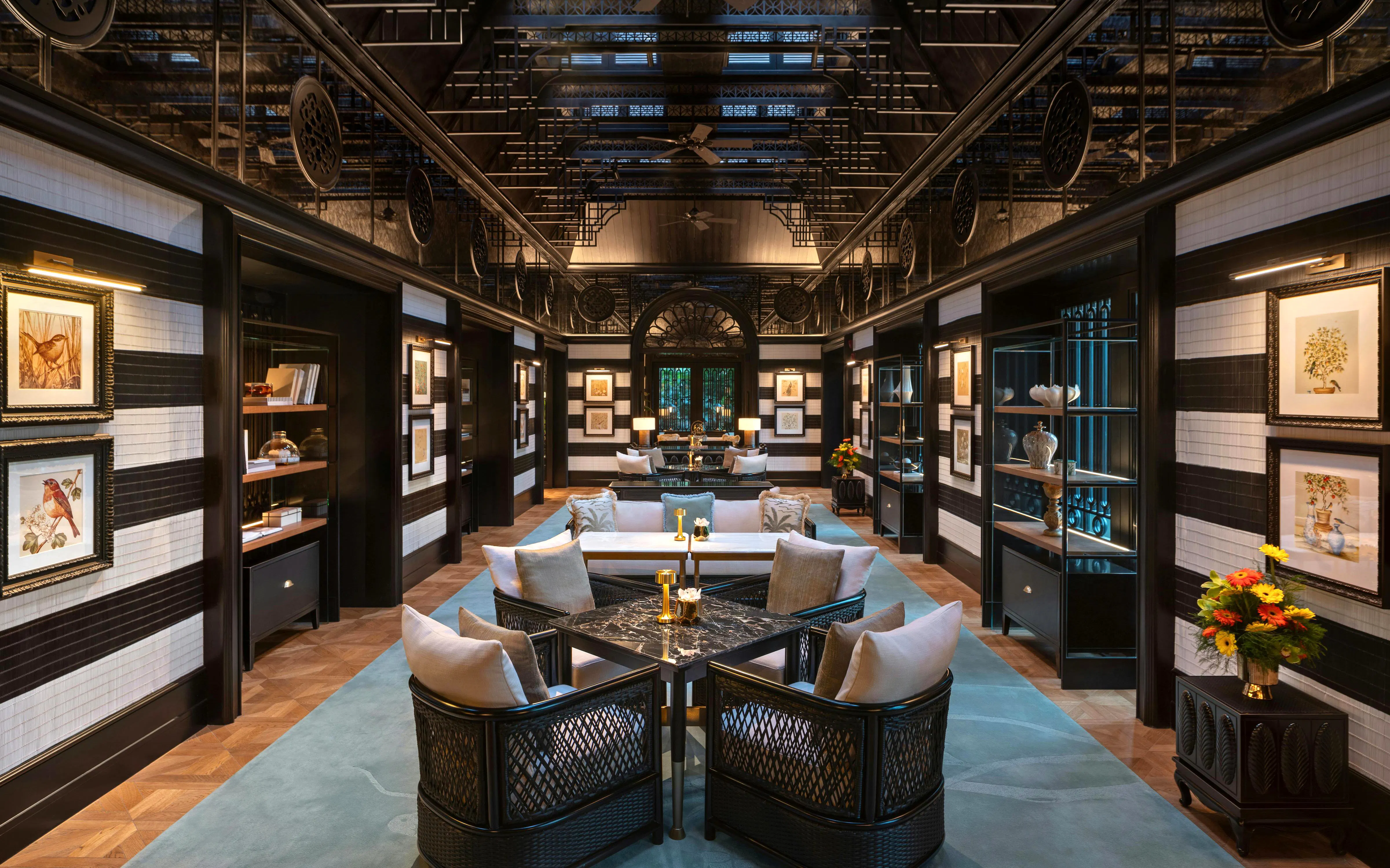 Upscale bar interior with dark wooden paneling and black marble counter at Resorts World Sentosa Singapore.