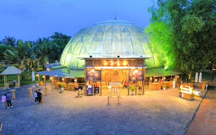 Teh Dar Vietnamese Bamboo Circus dome illuminated at night.