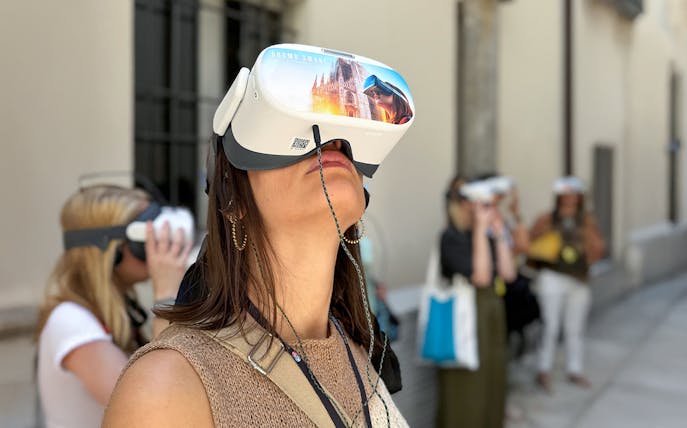 Woman experiencing Duomo Milan Cathedral VR tour.