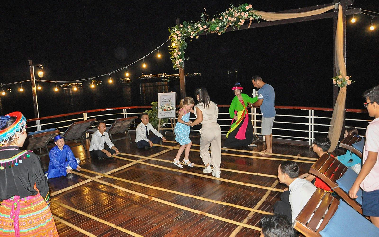 Bamboo dancing on Amanda Luxury Cruise deck at night.