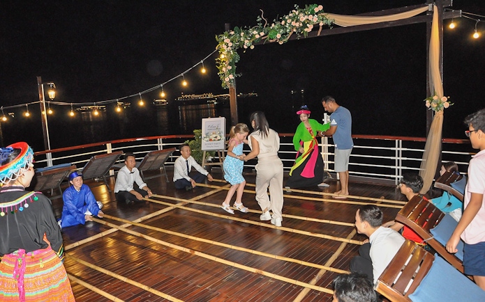 Bamboo dancing on Amanda Luxury Cruise deck at night.