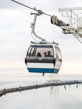 Telecabine Lisbon cable car over Tagus River with passengers.
