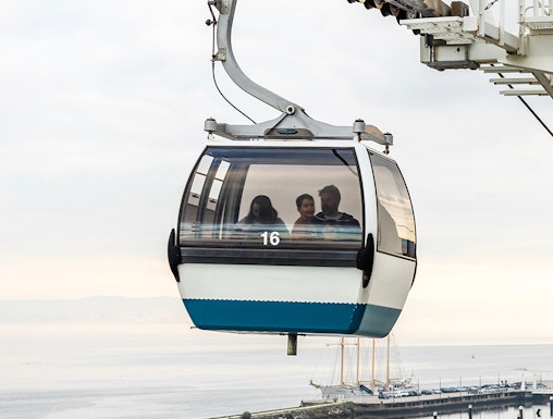 Telecabine Lisbon cable car over Tagus River with passengers.