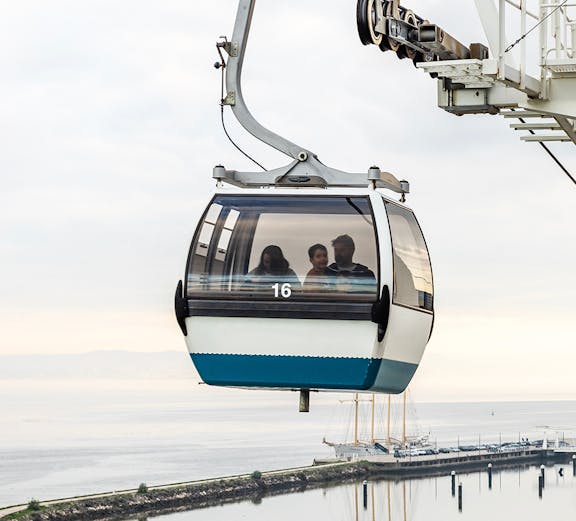 Telecabine Lisbon cable car over Tagus River with passengers.
