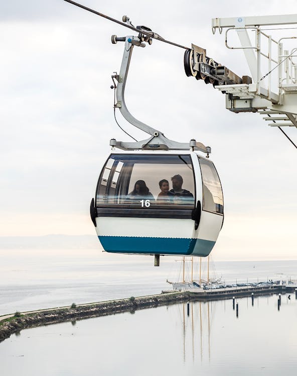 Telecabine Lisbon cable car over Tagus River with passengers.