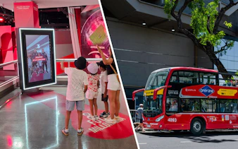 Visitors interacting with a digital display at Museo River in Buenos Aires, with a city tour bus nearby.
