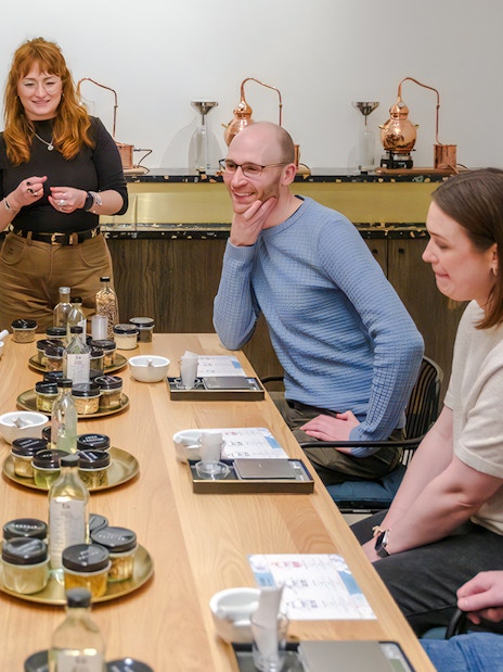 Guests enjoying a gin making experience with a host in Edinburgh.