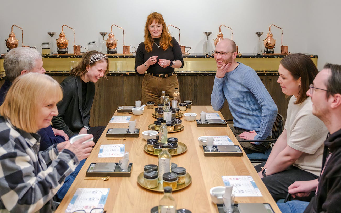 Guests enjoying a gin making experience with a host in Edinburgh.