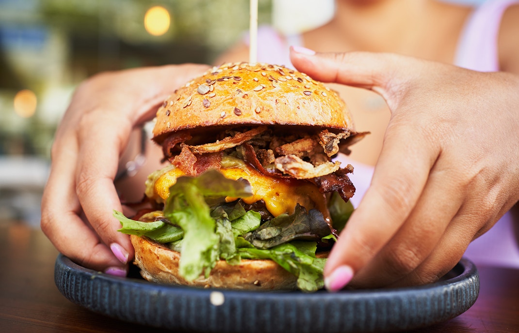 Visitors enjoying a juicy hamburger meal in Spain
