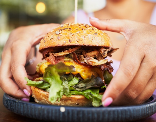 Juicy hamburger with lettuce, tomato, and cheese in New York City.