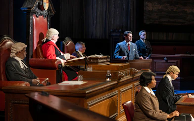Courtroom scene from "Witness for the Prosecution" performance with actors in legal attire.