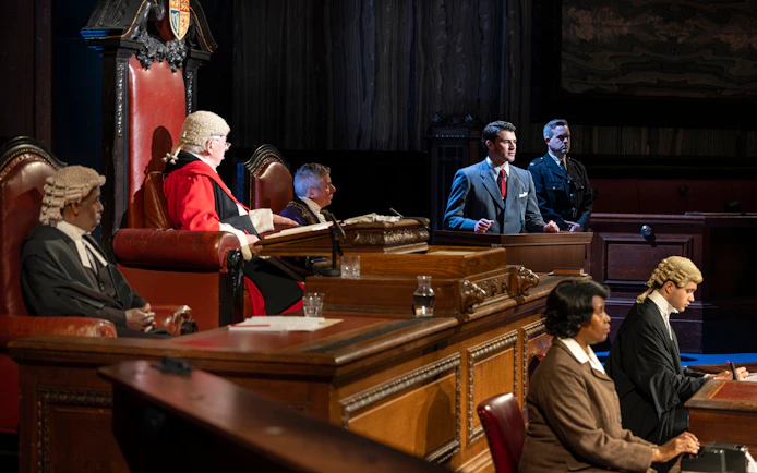 Courtroom scene from "Witness for the Prosecution" performance with actors in legal attire.