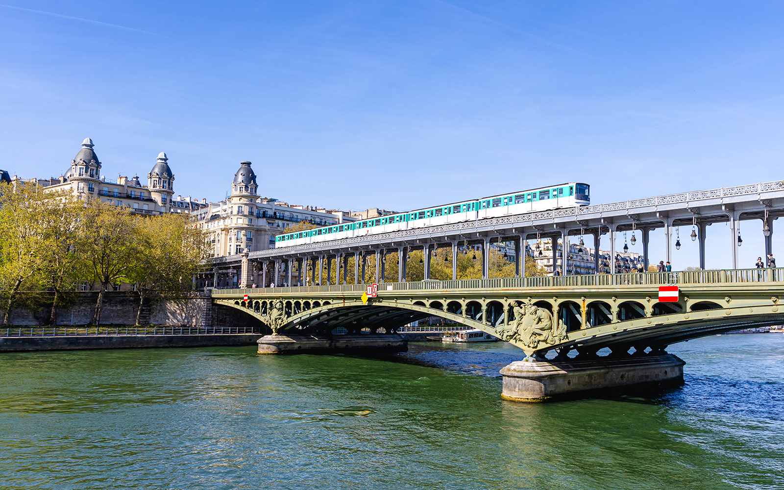 Train crossing Pont de Bir-Hakeim over the Seine River in Paris, France.