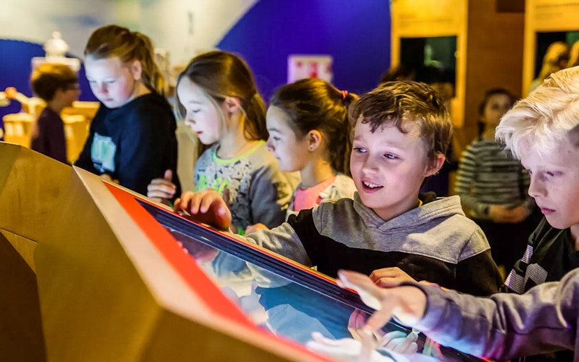 Children interacting with a display at This Is Holland 5D Ultimate Flight Experience.