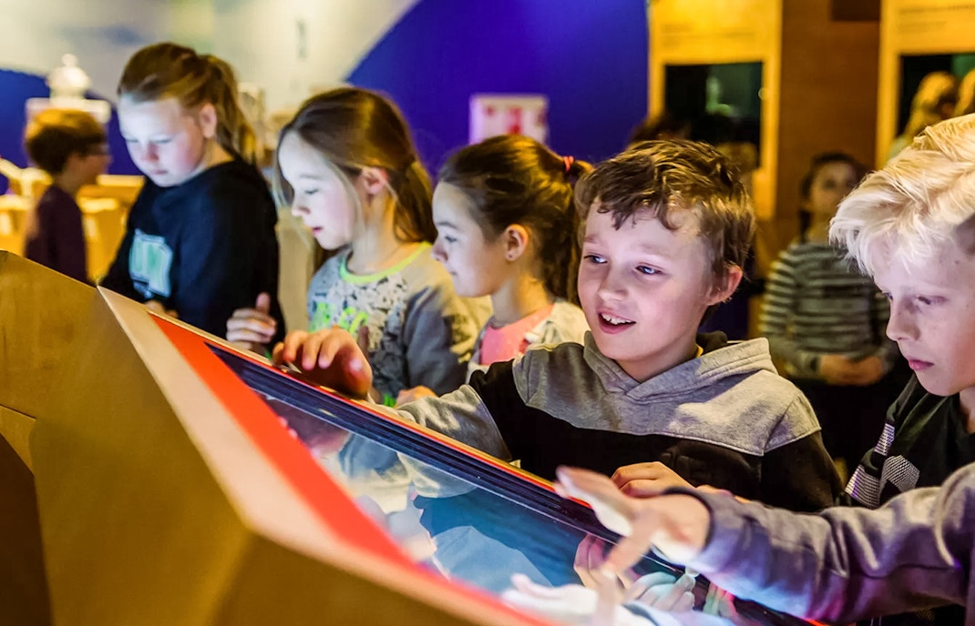 Children interacting with a display at This Is Holland 5D Ultimate Flight Experience.