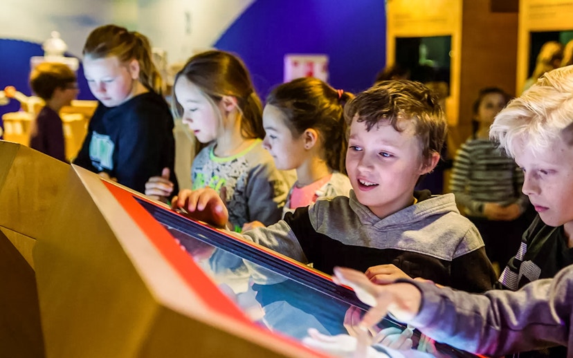 Children interacting with a display at This Is Holland 5D Ultimate Flight Experience.