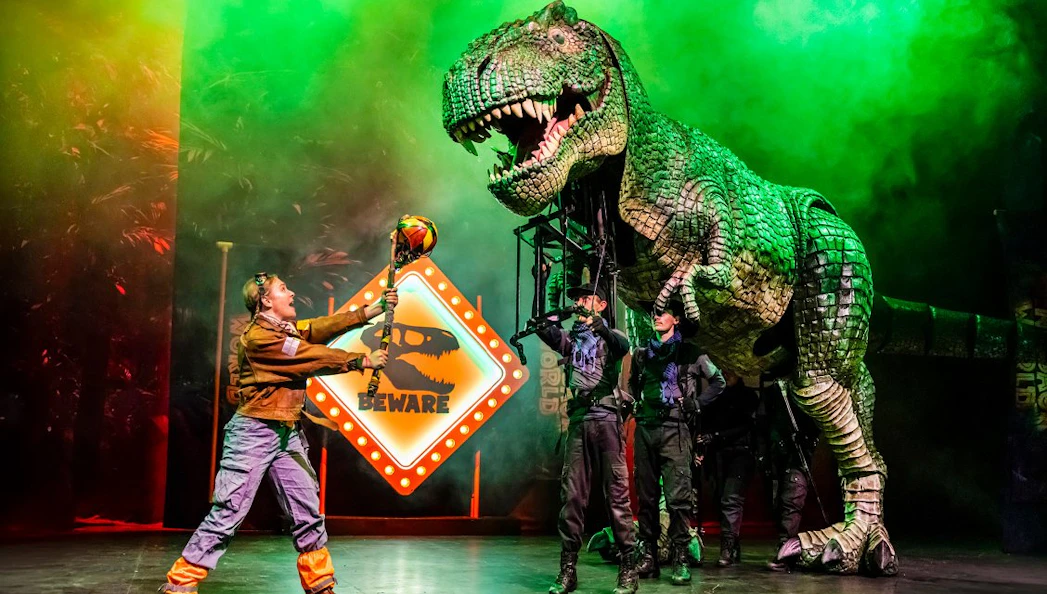 Stage performance of Dinosaur World Live with a large dinosaur puppet, Westend.