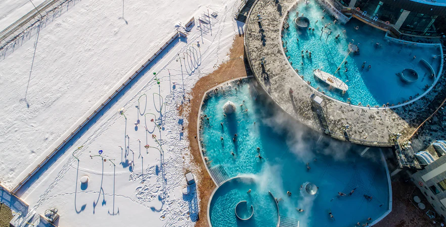 Aerial view of Chochołów Thermal Baths with snowy landscape, part of Krakow skiing tour.