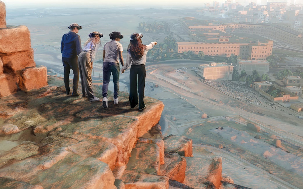 Visitors using VR headsets on a cliff overlooking the Horizon of Khufu virtual landscape.
