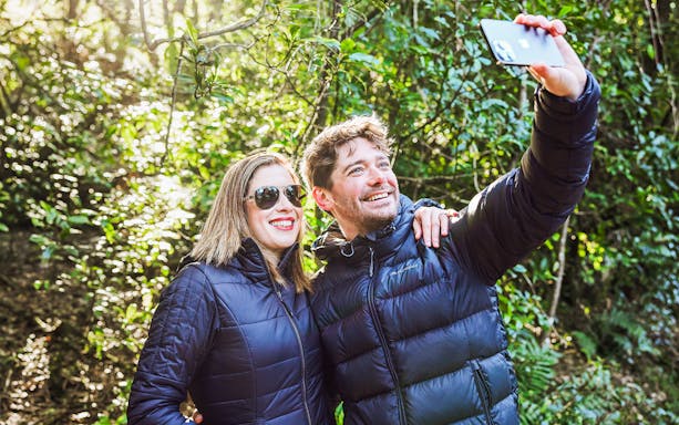 Couple taking a selfie in a forest at Scenic World, Australia.