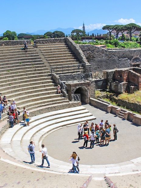 Tour group with guide in ancient theatre, Pompeii.