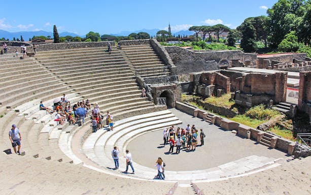 Tour group with guide in ancient theatre, Pompeii.