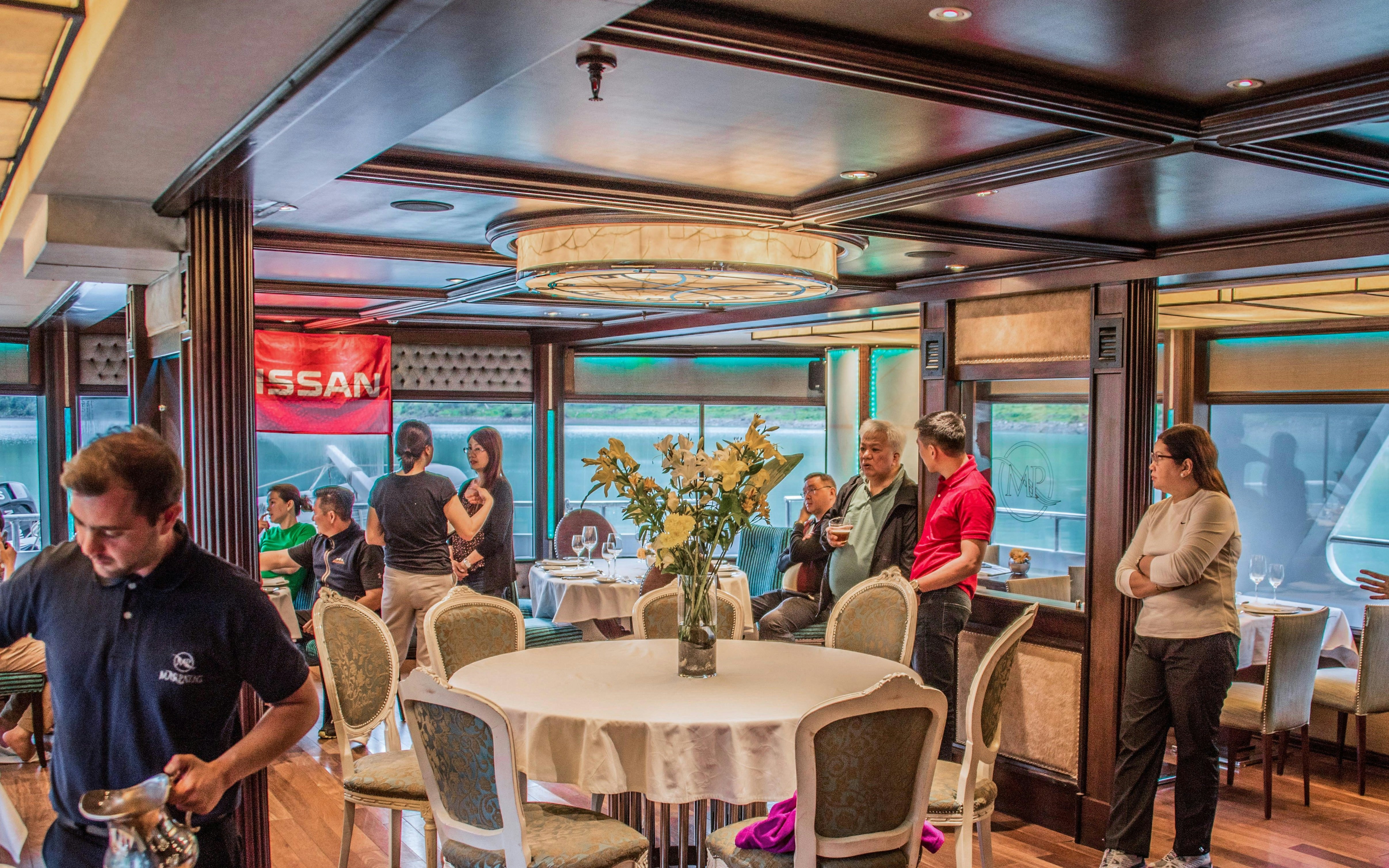 Tourists dining on a boat during the Spirit of the Glaciers tour.