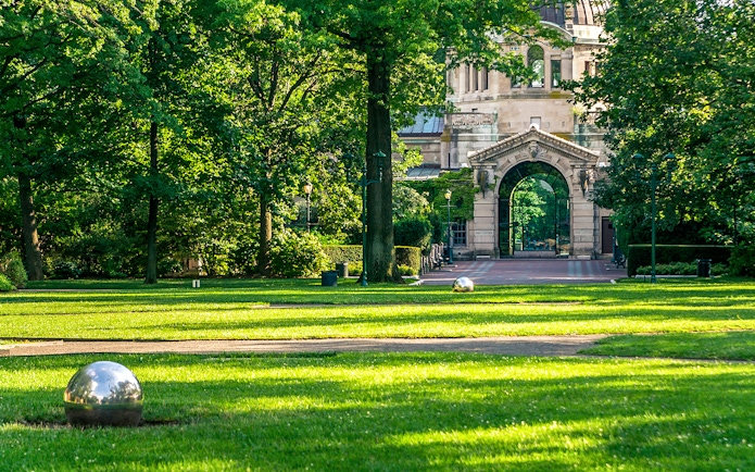 Entrance archway at Bronx Zoo surrounded by lush greenery.