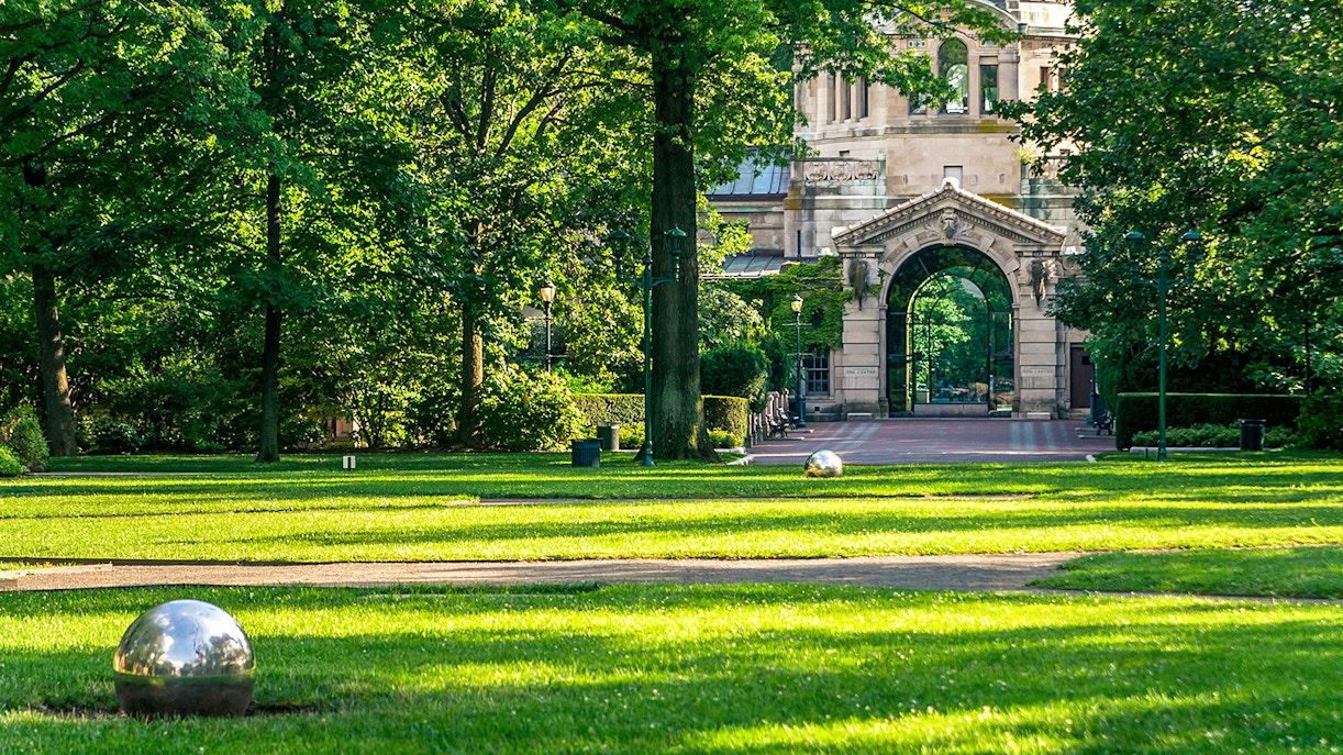 Entrance archway at Bronx Zoo surrounded by lush greenery.