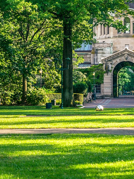 Entrance archway at Bronx Zoo surrounded by lush greenery.