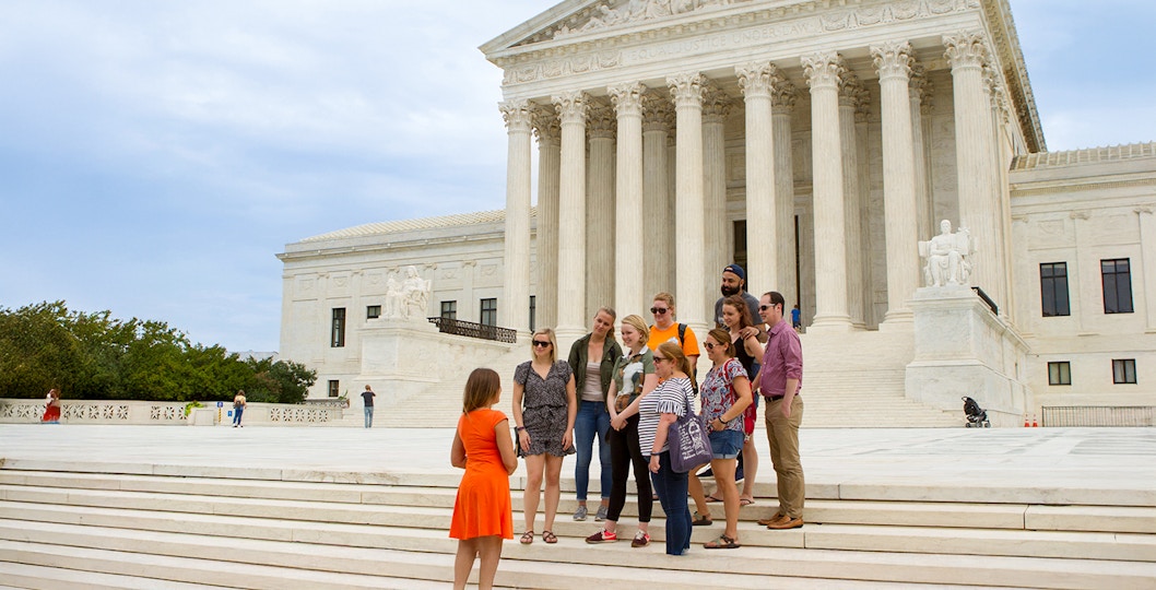 Guide discussing the Supreme Court with tourists in Washington D.C.