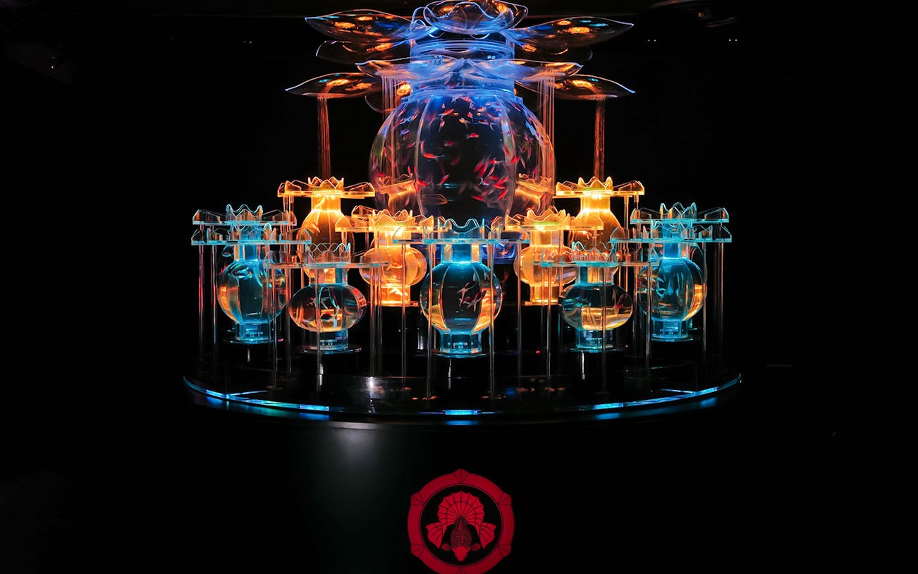 Illuminated flower-shaped goldfish aquarium at Art Aquarium Museum GINZA, Tokyo.