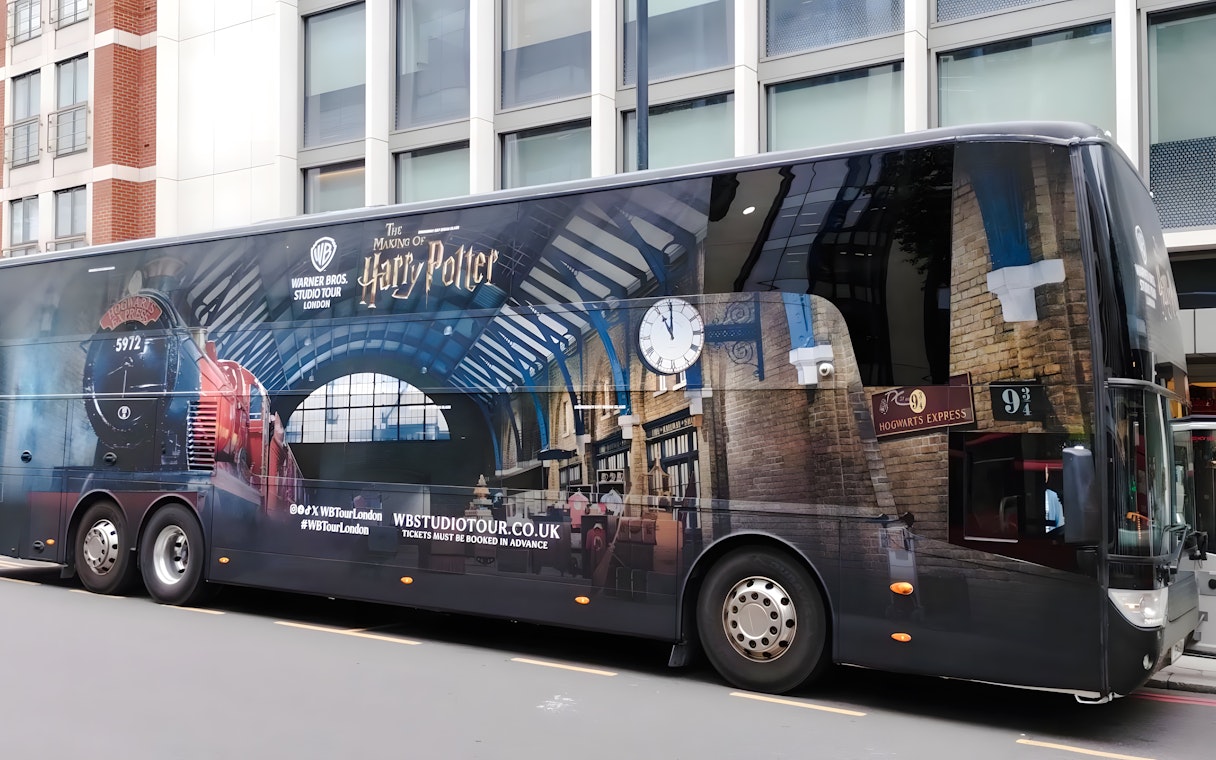 Harry Potter Warner Bros. Studio Tour coach in London with Hogwarts Express design.